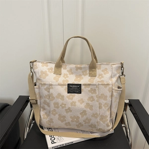 Floral multi-pocket tote bag with adjustable strap for versatile shoulder or crossbody use