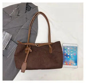 Size comparison of a large vintage brown faux suede tote bag next to a white tablet