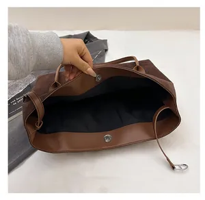 Top view of large brown suede tote bag showing spacious interior and magnetic snap closure