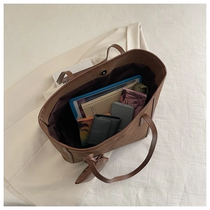 Top view of spacious brown suede tote bag showing internal capacity for tablets and books