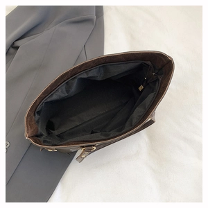 Macro detail of the spacious interior with zipper pocket in a vintage brown tote bag