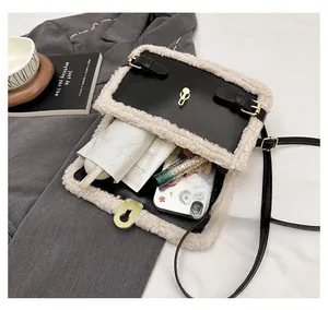 Detail view of leather and lamb wool crossbody bag showing spacious interior capacity