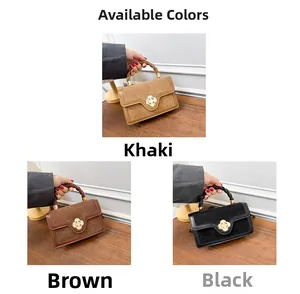 Detailed close-up of khaki brown and black suede handbags with gold flower clasps