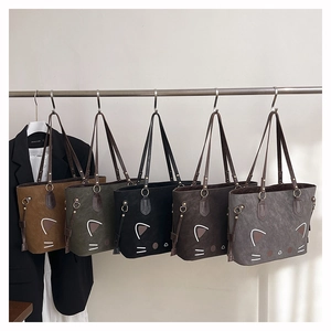 Detailed view of the five color variations of tote bags with cute cat face design