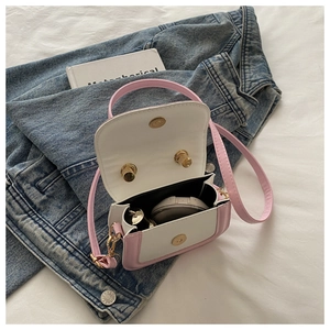 Interior view of pink and white mini crossbody bag showing lipstick and makeup storage