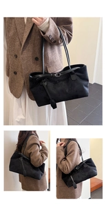 Detail of black suede tote bag with decorative buckle and hanging charm for women
