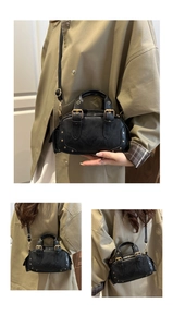 Detail of vintage black bowling bag with gold rivets and shiny leather texture