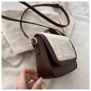 Detail of vintage faux shearling and brown leather crossbody bag with gold hardware