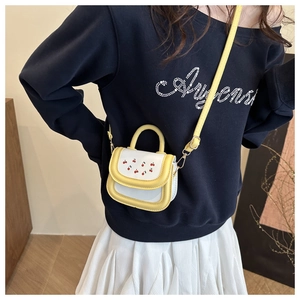 Mini cherry crossbody bag in yellow and white faux leather with an adjustable strap