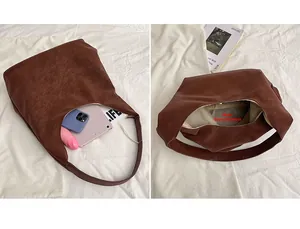 Detailed view of spacious brown tote bag interior holding a tablet and magazine