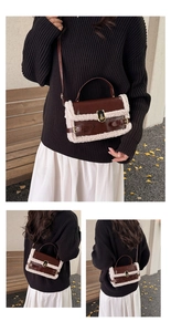 Detail view of brown leather bag with white faux fur trim and gold metal clasp