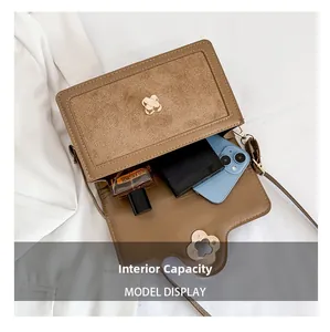 Detail view of the brown crossbody bag interior showing storage space for phone and wallet