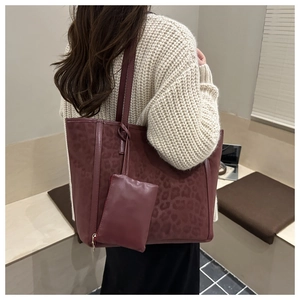Close-up of burgundy leopard print suede tote bag with matching zippered coin purse