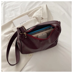Top view of spacious burgundy PU leather tote bag with glossy finish and gold zipper detail