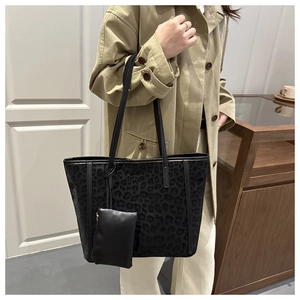 Close-up of leopard pattern suede tote bag with matching mini zipper pouch on model