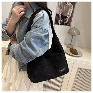 Détail du sac cabas en velours côtelé noir montrant la texture et l'étiquette Fashion