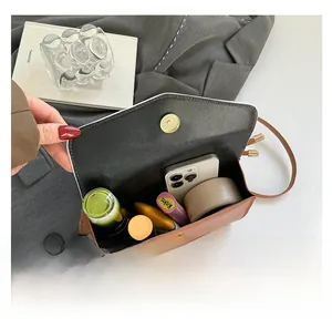 Interior view showing the large storage capacity of this brown flap crossbody bag