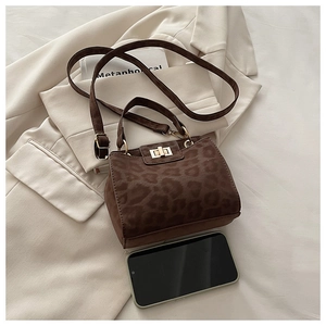 Leopard print crossbody bag shown with a smartphone for size comparison and perspective