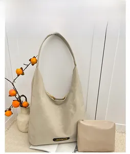 Detail of off-white faux leather tote bag with matching inner pouch and logo