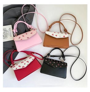 Detailed view of mini flap crossbody bags with cute strawberry and heart prints