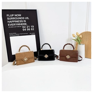 Three retro handbags with flower clasps and twist handles in brown, black, and yellow