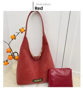 Detail of red oversized tote bag with matching inner pouch and jacqueue brand logo