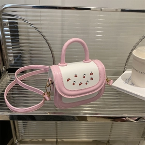 Pink and white handbag with cherry print, dual handles and crossbody strap