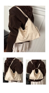 Detail view of large soft leather tote showing adjustable straps and chic zip closure