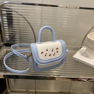 Chic cherry print mini crossbody bag in light blue and white color block design