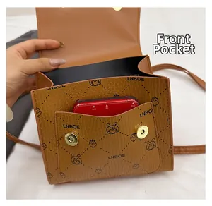 Detail view of the brown retro crossbody bag featuring a functional front pocket storage