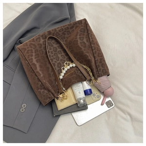 Interior view of leopard print tote bag with pearl chain showing large storage capacity