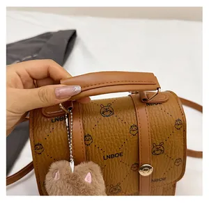 Detailed view of brown litchi pattern bag with LNBOE logo and cute cartoon animal prints