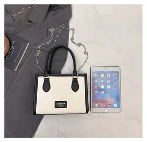 Top view of beige plaid crossbody bag showing size comparison next to a tablet and blazer