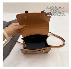 Internal view of brown leather bag showing spacious main compartment and zip pocket