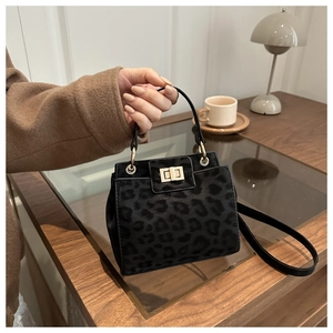Detail view of square leopard print bag with velvet texture and metal twist lock