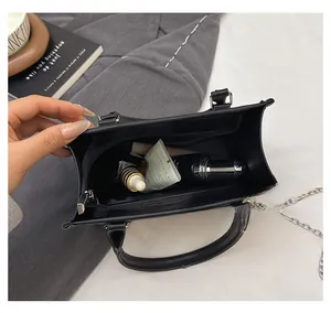 Top view showing the spacious interior of this black leather tote with a zipper pocket