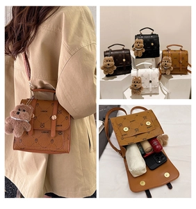 Detail view of mini backpack interior showing capacity for phone and cosmetics