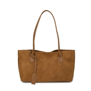 Brown faux suede tote bag with decorative vertical stitching and long shoulder straps