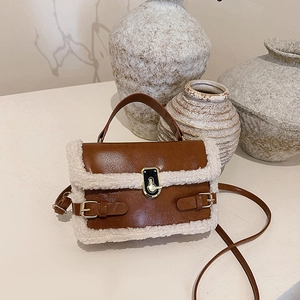 Brown leather shoulder bag with white faux fur trim and metal buckle closure