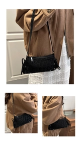 Detail of leopard print shoulder bag with side drawstrings and reinforced metal studs