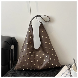 Detailed close-up of brown PU leather shoulder bag featuring vintage golden stud accents
