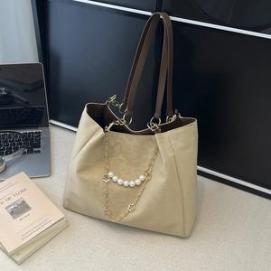 Chic beige tote bag with pearl chain and brown straps, styled for office and daily use