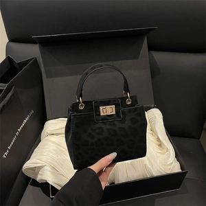 Luxury black animal print handbag with gold clasp in a premium gift box set