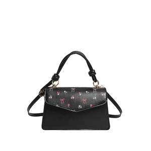 Black floral square handbag with pink bow print and golden metal rings on white background
