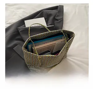 Macro view of interior storage space and chain strap for tweed green luxury handbag