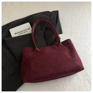 Close-up of burgundy suede tote bag with large capacity and vintage texture
