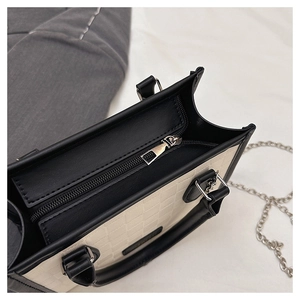 Detailed top view of checkerboard tote bag showing zipper closure and interior capacity
