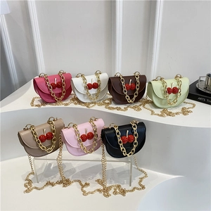 Mini semi-circular saddle bags with cherry charms and gold chains in seven vibrant colors