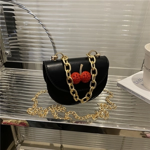 Fashionable black leather saddle bag with rhinestone cherry and golden metal chains