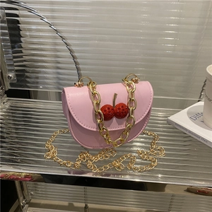 Pink mini crossbody bag with cherry decor and gold chain strap for stylish women